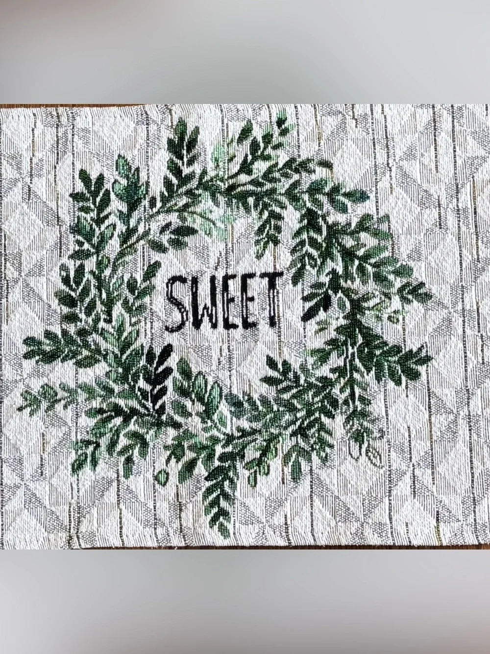 Festive White Table Runner with Green Wreath Motifs “Home Sweet Home”.